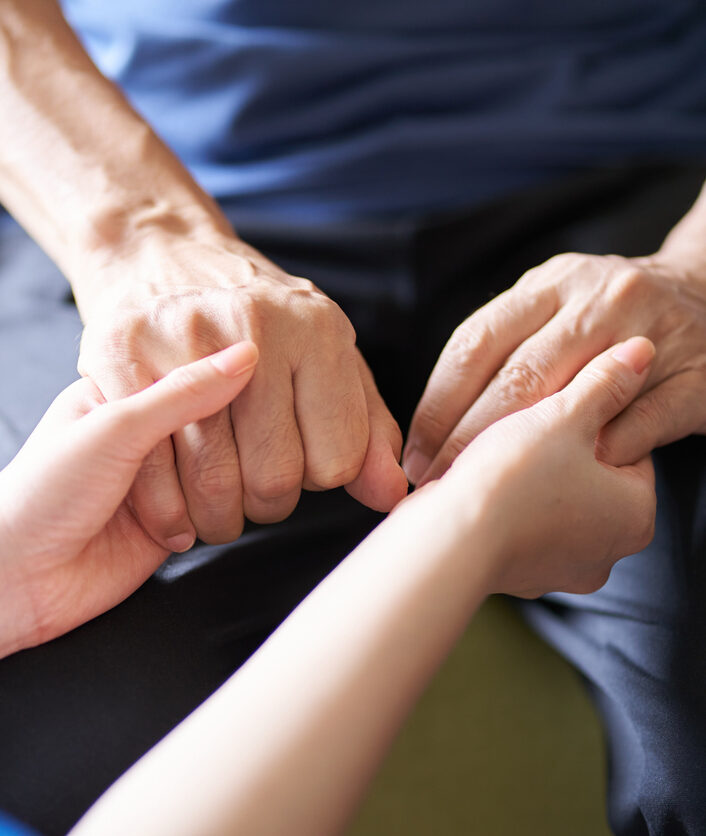 Hands of caregivers and the elderly